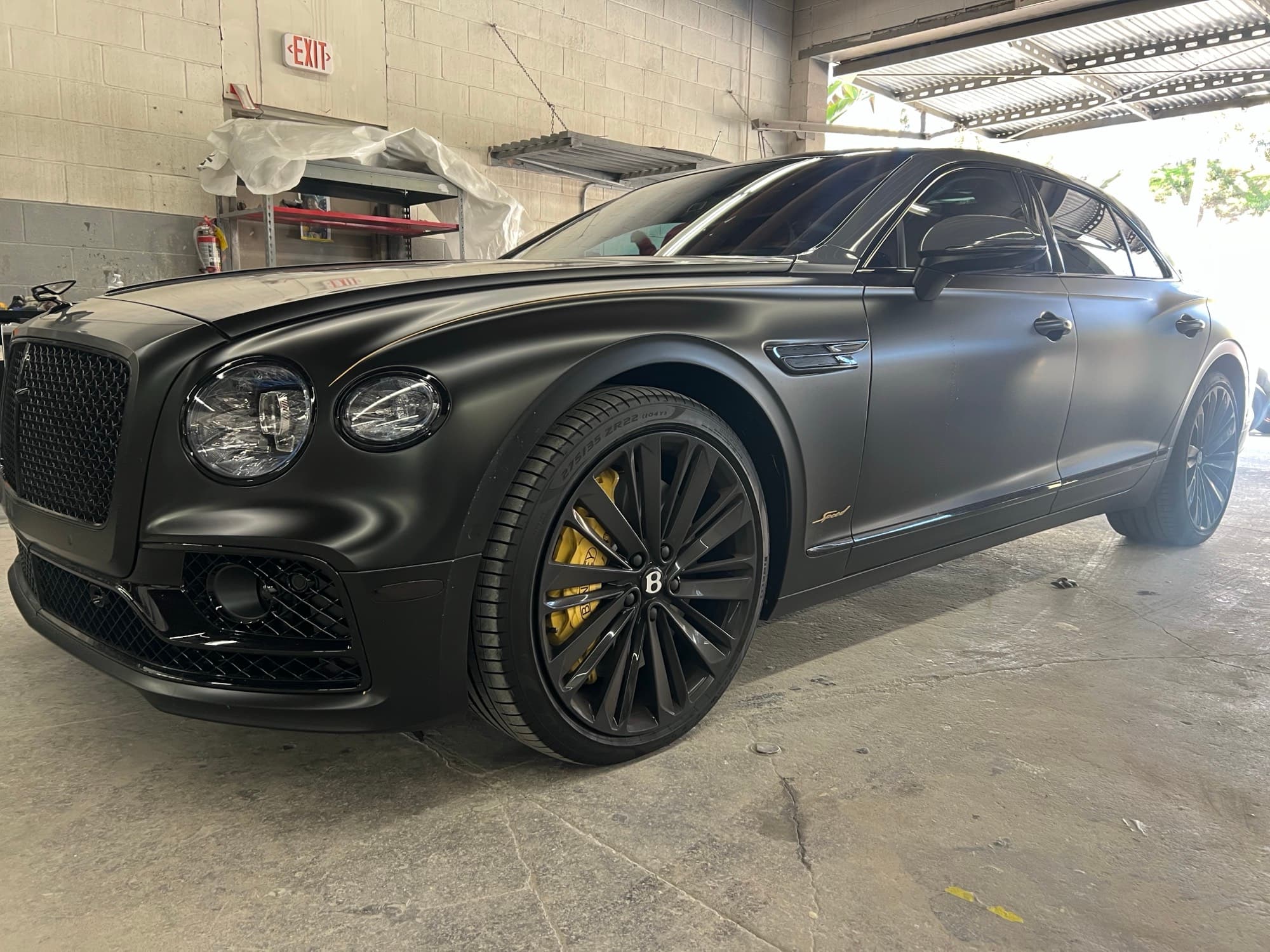 Bentley Flying Spur sedan in the Crash Lab interior bay during QC